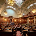 A beautifully designed chamber room with ornate woodwork and chandeliers in the UK.